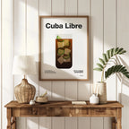 Framed 'Cuba Libre' poster on a wall above a wooden console table with decorative items.