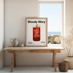 Framed 'Bloody Mary' poster on a wooden table with a window view.