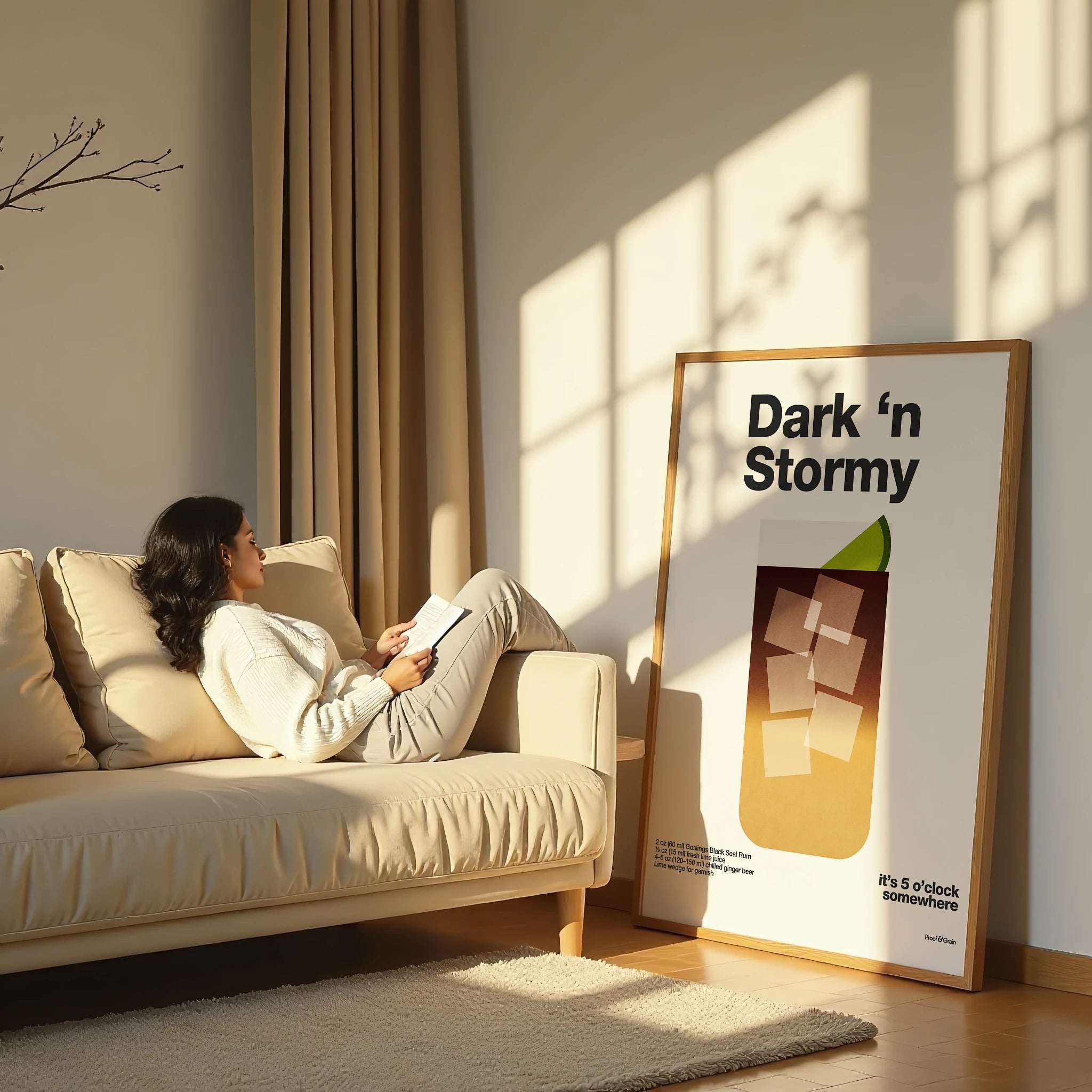 Woman reading a book on a couch in a sunlit room with a framed poster titled 'Dark 'n Stormy' on the wall.