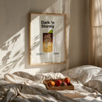 Framed artwork titled 'Dark 'n Stormy' on a wall above a bed with fruit tray.