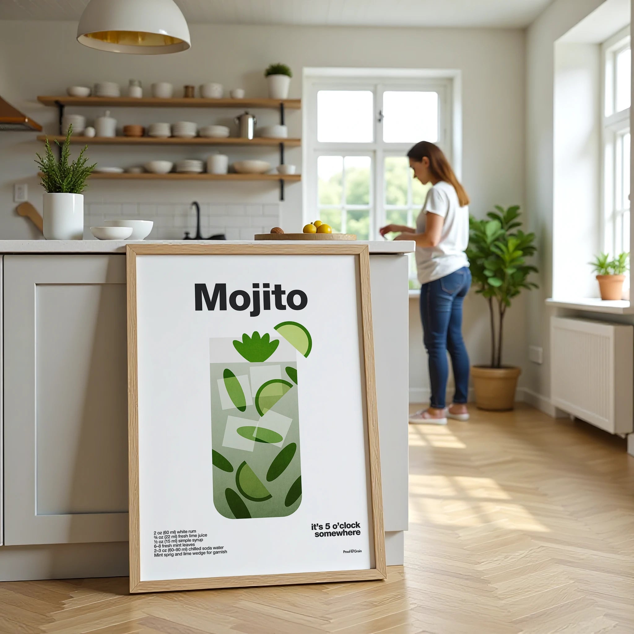 Framed Mojito poster on a kitchen counter with a woman in the background