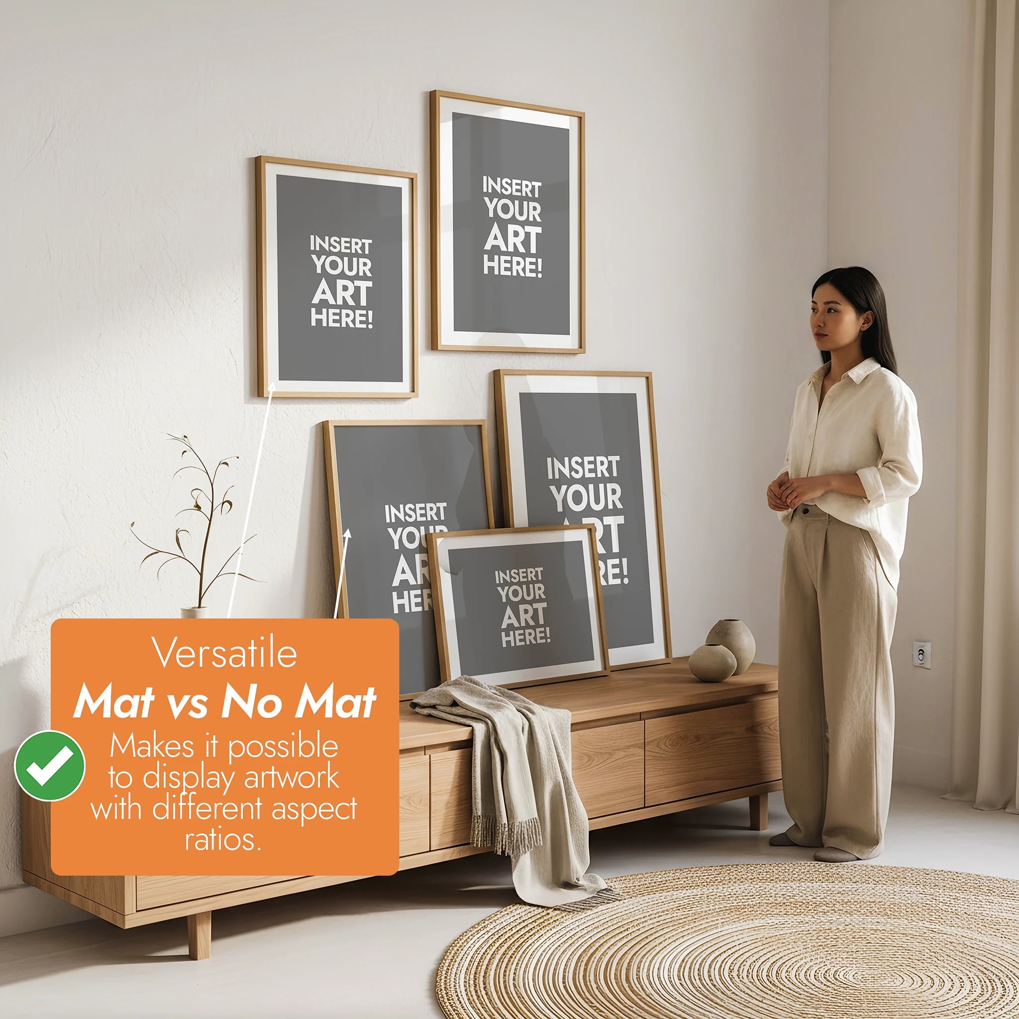 Woman standing in a room with framed art on the wall, promoting the versatility of matting for artwork [Proof & Grain]
